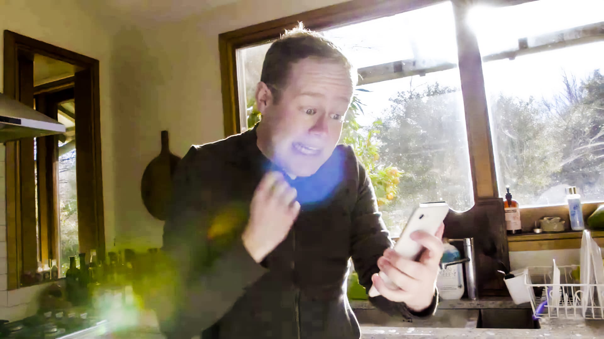 Mark Darbyshire looks at his smartphone in panic
