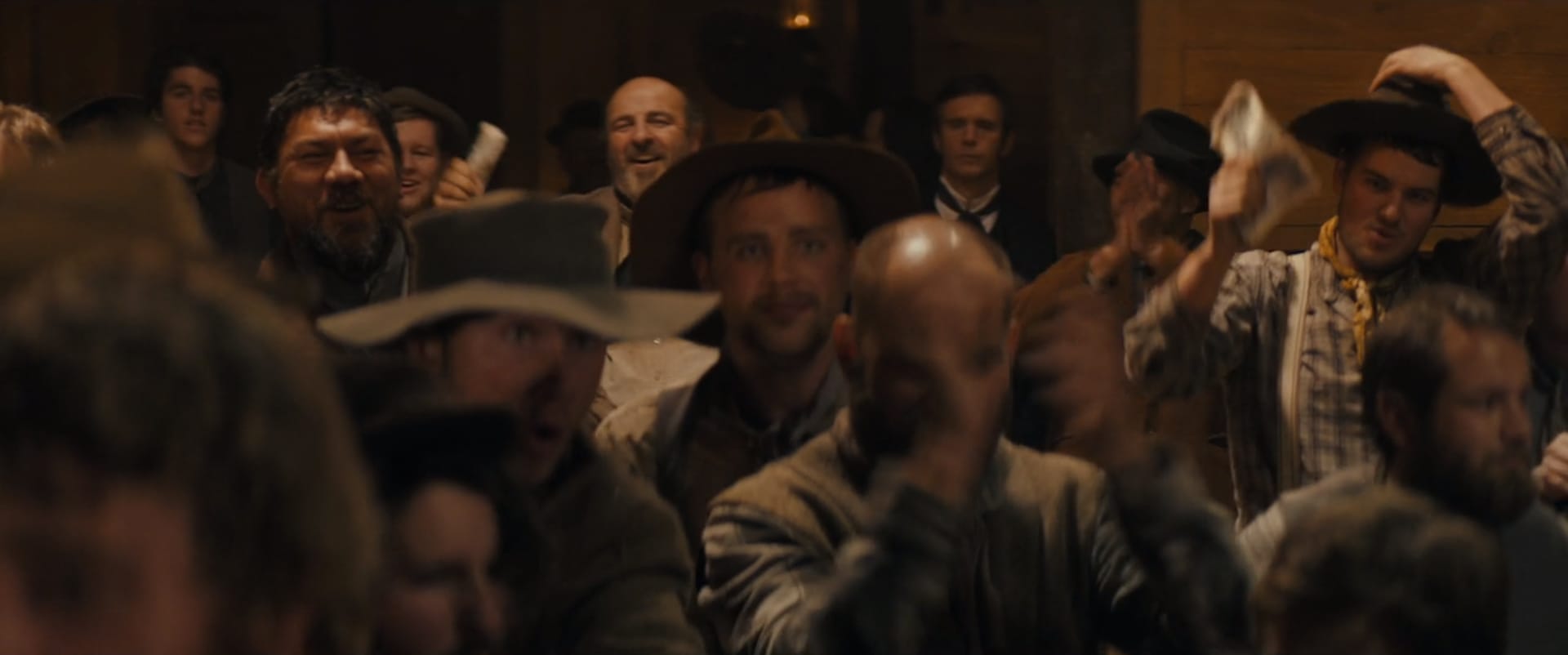 A rabble of excited miners in a 19th-century saloon.